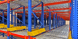 Orange and blue pallet racks with yellow safety bumpers featuring rollers