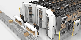 Two workers move packages from the conveyor system to the horizontal carousels to store inventory in a warehouse
